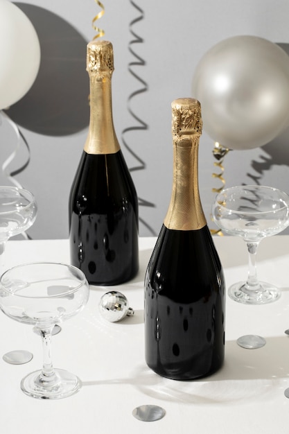 Free photo new year party arrangement with champagne bottle