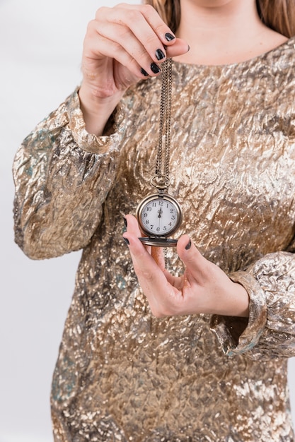 Free photo new year party concept with girl holding clock