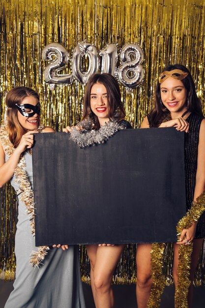 New year party concept with girls showing chalkboard