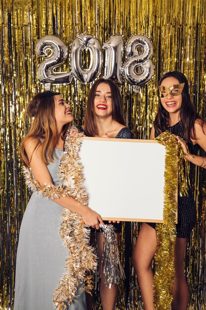 New year party concept with girls showing whiteboard