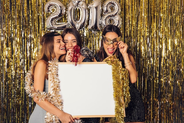 New year party with girls holding whiteboard