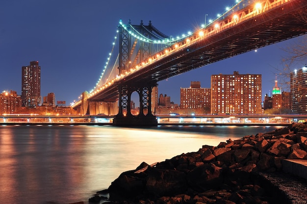 New York City Manhattan Bridge closeup with downtown skyline over East River.