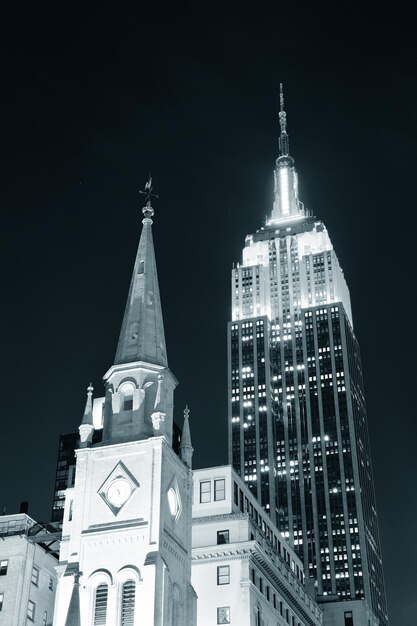 NEW YORK CITY, NY - DEC 30: Empire State Building and church on December 30, 2011 in New York City. It is a 102-story landmark and was world's tallest building for more than 40 years.