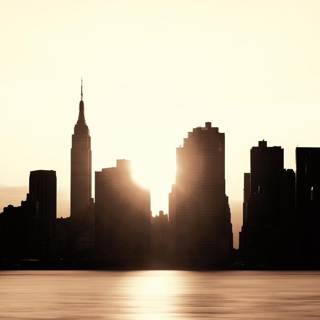 New York City skyscrapers silhouette urban view at sunrise.