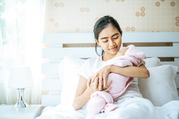 newborn baby sleeping in the embrace of the mother