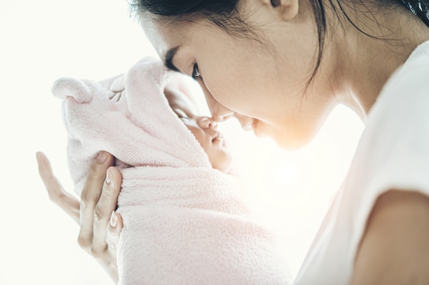 newborn baby sleeping in the hands of the mother and the nose collided