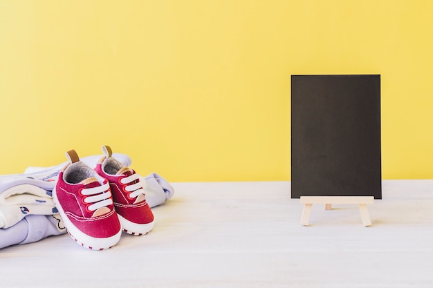 Newborn concept with board and shoes