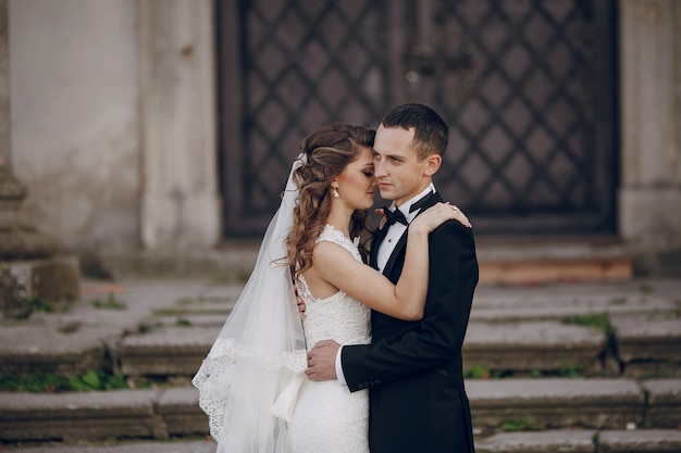 Newlyweds embracing each other on the stairs