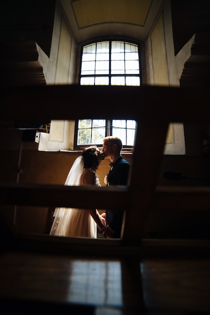 Free photo newlyweds kissing in the dark