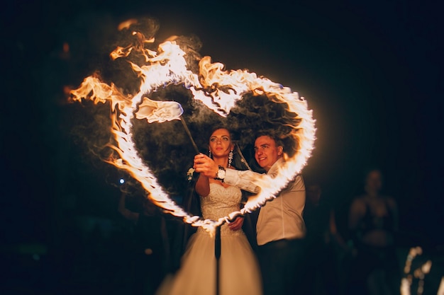 Free Photo newlyweds llighting a fire hear