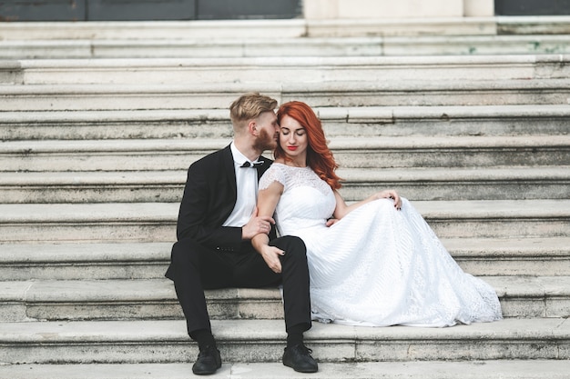 Newlyweds sitting on stairs