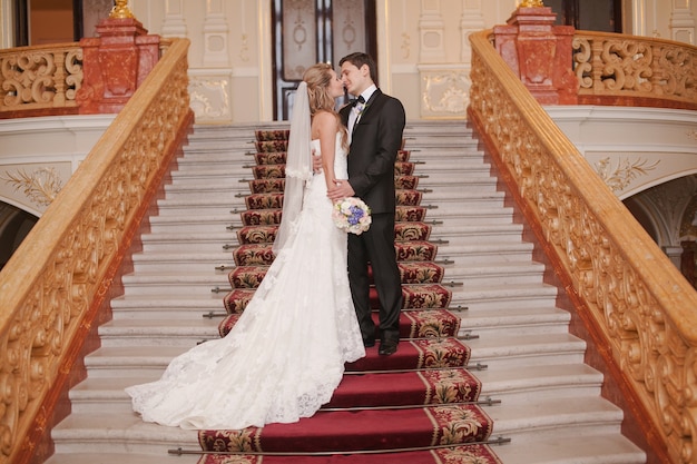 Newlyweds in a stairs kissing