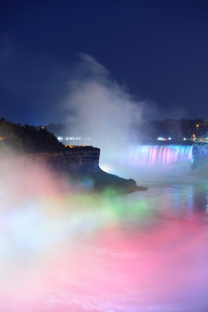 Free Photo niagara falls lit at night by colorful lights