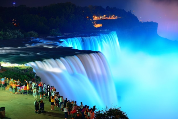 Free Photo niagara falls lit at night by colorful lights