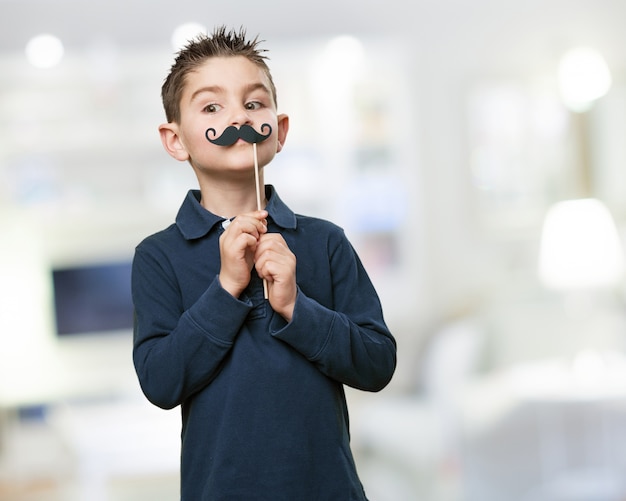 Free Photo nice boy posing with a fake mustache