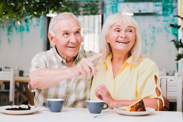 Free photo nice elderly couple looking away with smile