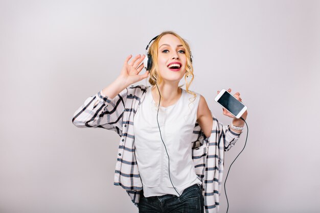 Nice pretty portrait of delighted gorgeous woman with blonde hair. Music happy girl dancing against Party time. Leisure. Active positive lifestyle