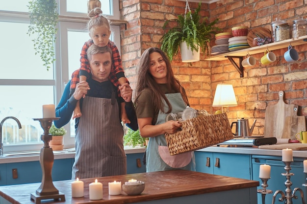 Free photo nice small family are together at the kitchen, they planning to cook something.