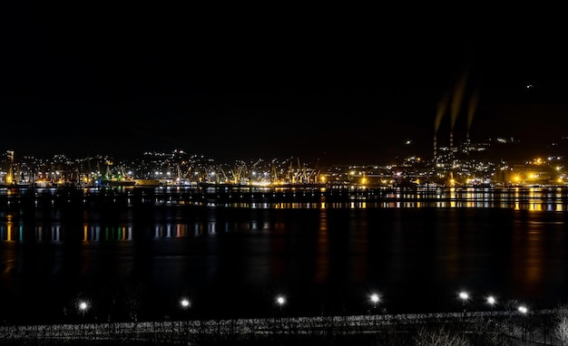 Free Photo night panoramic view of the port cranes and other port infrastructure novorossiysk trading port on the black sea tsemesskaya bay