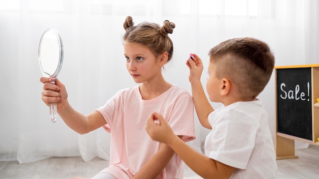 Non binary children playing a beauty salon game together