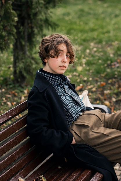 Free Photo non binary person sitting on a bench