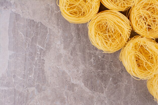 Noodle tops isolated on marble surface