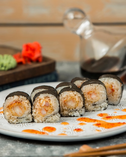 Free Photo nori sushi rolls with shrimp garnished with sweet chili sauce