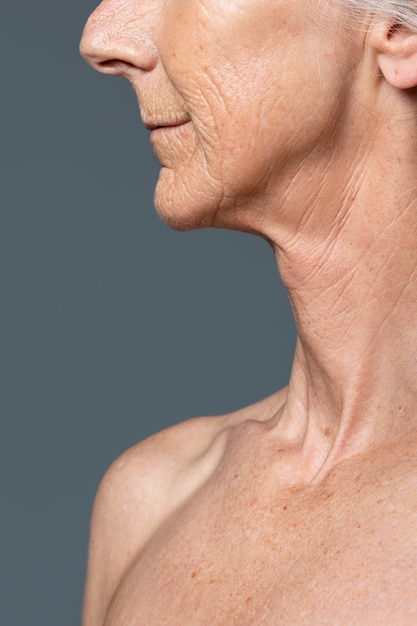 Free photo normal skin texture senior woman side view