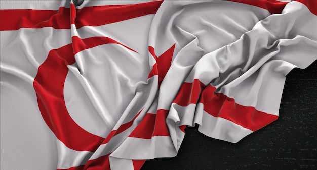 Free photo northern cyprus flag wrinkled on dark background 3d render