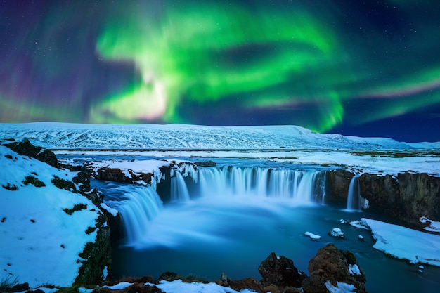 Northern Light, Aurora borealis at Godafoss waterfall in winter, Iceland.