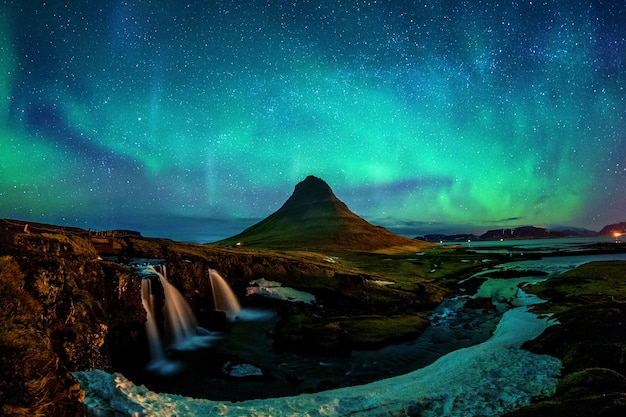 Free Photo northern light, aurora borealis at kirkjufell in iceland. kirkjufell mountains in winter.