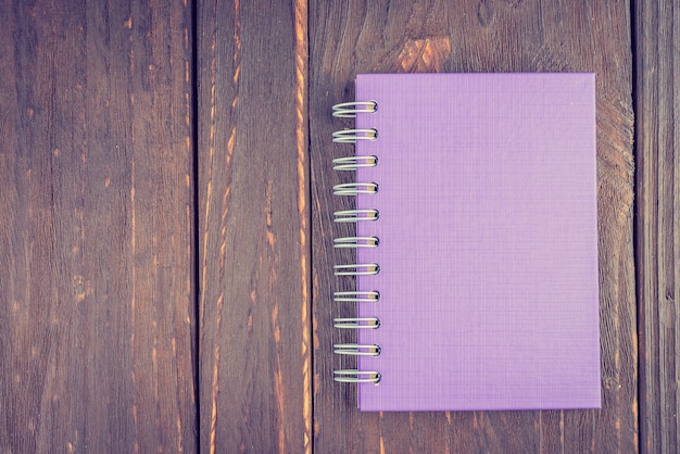 Note book on wooden background