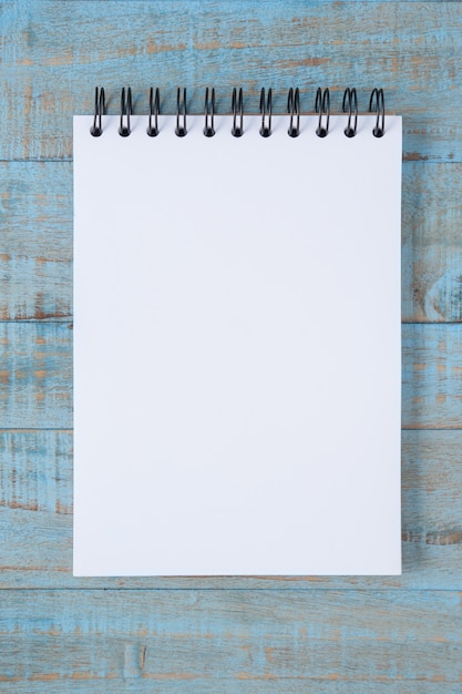 Free Photo notebook on blue wood table 