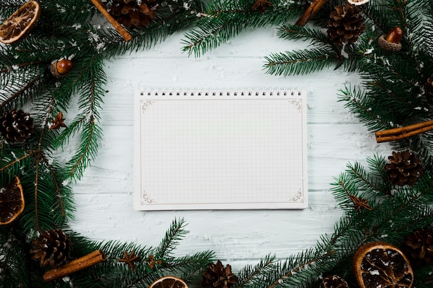 Free photo notebook between fir twigs