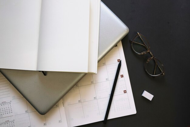 Notebook and laptop on calendar