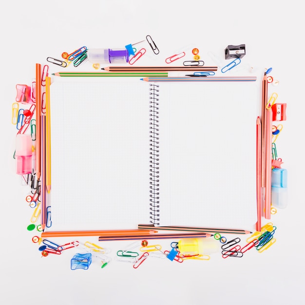 Free Photo notebook lying with school stationery