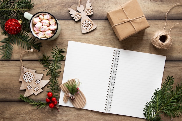 Free Photo notebook mock-up surrounded by christmas decorations