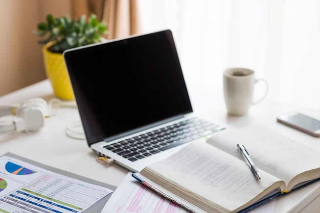 Notebook near laptop on table