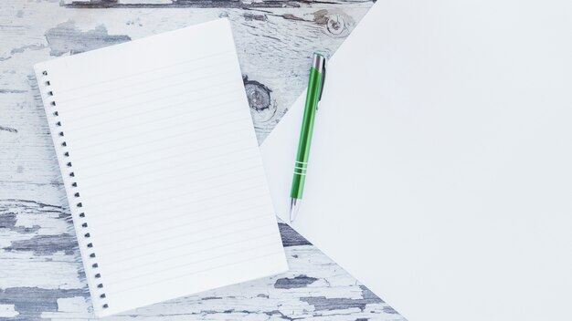 Notebook and paper on wooden shabby desk