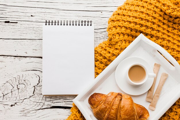 Notebook and tray with breakfast