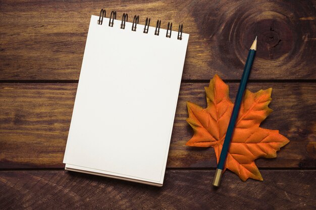 Notebook with autumn maple leaf composition 