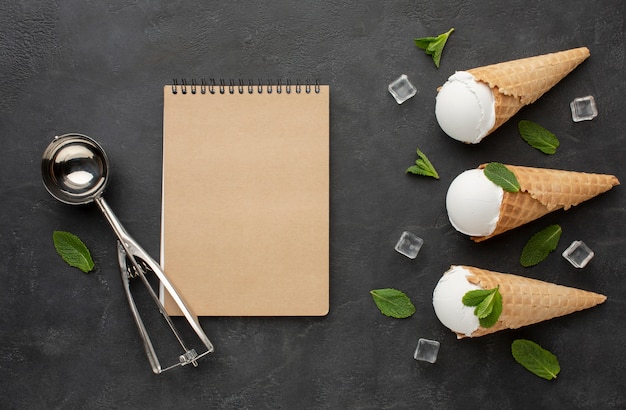 Notebook with ice cream on cones with ice cubes