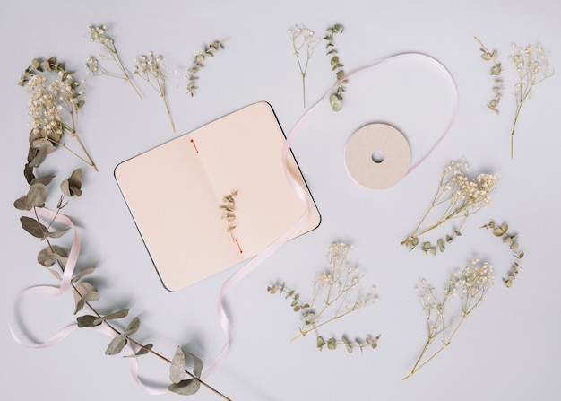 Free photo notebook with small branches on table