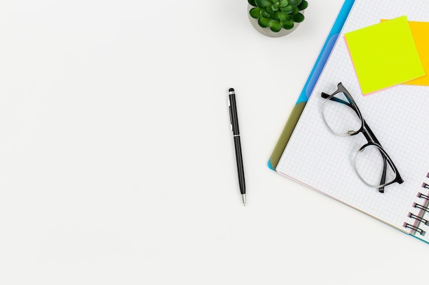 Free photo notepad glasses pen and paper reminders on a white background