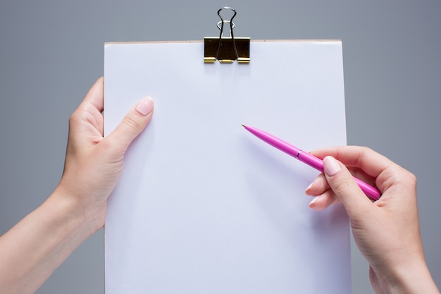 notepad and pen in female hands