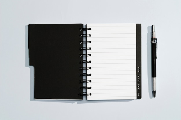 Free photo notepad with black covers and pen