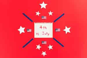 Free photo notepad with inscription 4th of july and design with stars on red surface