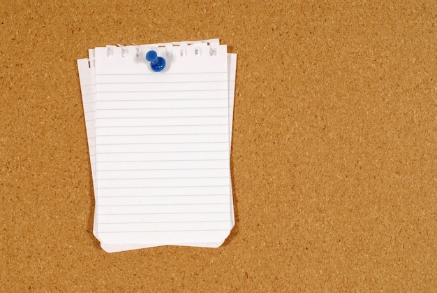 Free photo notepaper pinned to a cork board