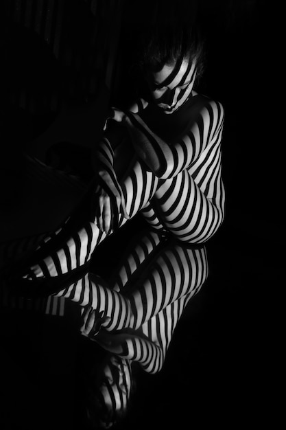 Nude woman with black and white stripes