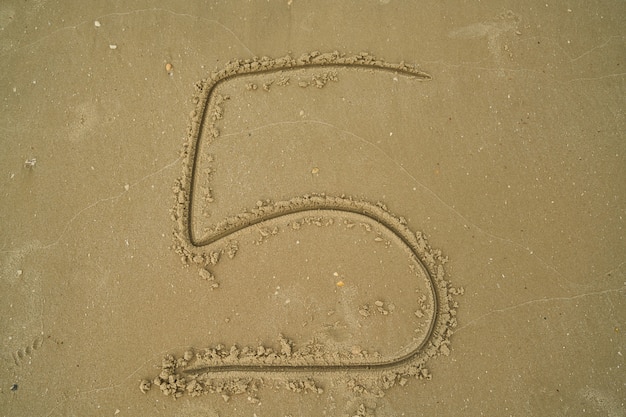 Free Photo number written in the sand